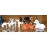 A SELECTION OF BESWICK BRANDED ANIMALS to include; ponies, four hunting hounds, and a recumbent fox