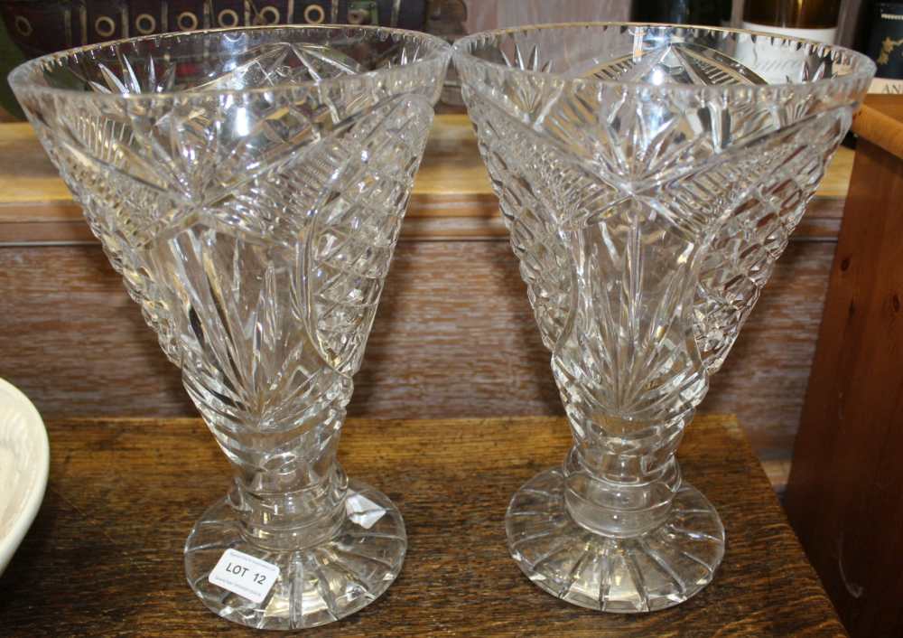 A PAIR OF CUT GLASS TRUMPET SHAPED VASES, on star cut pedestal foot, 29cm high