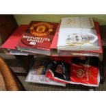 TWO SHELVES CONTAINING A LARGE COLLECTION OF MANCHESTER UNITED EPHEMERA & COLLECTABLES