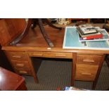 A MID 20TH CENTURY OAK FINISHED INSTITUTIONAL STYLE TWIN PEDESTAL DESK, having two pull out slides