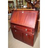 A NATHAN BRANDED REPRODUCTION MAHOGANY COLOURED BUREAU of typical form, together with a circular