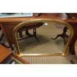 A 20TH CENTURY GILT FRAMED ARCH TOPPED BEVEL PLATE OVER MANTEL MIRROR