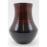 A MOORCROFT POTTERY VASE of ribbed tapering form, fading flambe to black glaze, impressed factory