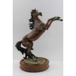 A CAPO-DI-MONTE RESIN MODEL of a rearing horse, after "Giuseppe Armani", on polished wood base,