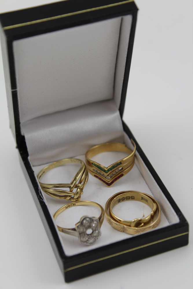 A SELECTION OF FIVE RINGS comprising; an 18ct gold buckle form ring, together with; a 9ct gold