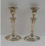JAMES DIXON, A PAIR OF SILVER CANDLESTICKS, Sheffield 1907, fluted columns with harebell swags, on