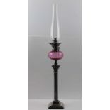 A FRENCH OIL LAMP BY "GAUDARD" having cranberry glass reservoir over a silver plated Corinthian