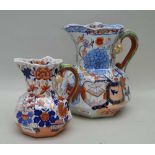 TWO 19TH CENTURY IRONSTONE JUGS with lizard handles, the larger indistinctly impressed, the