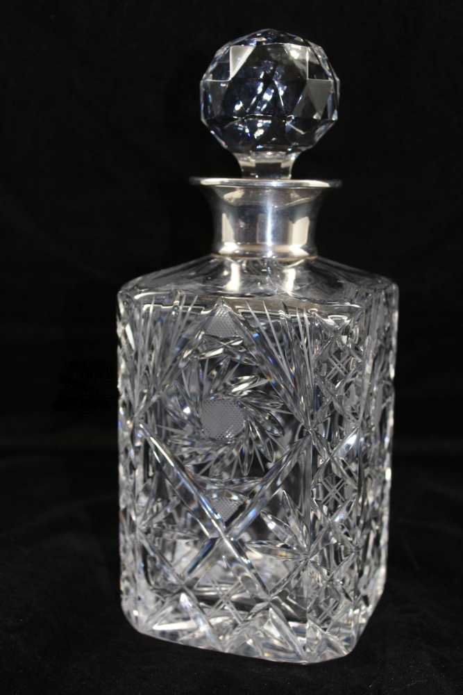 ROBERTS & DORE LTD A CUT GLASS DECANTER with silver mounts, London 1967, with faceted ball stopper