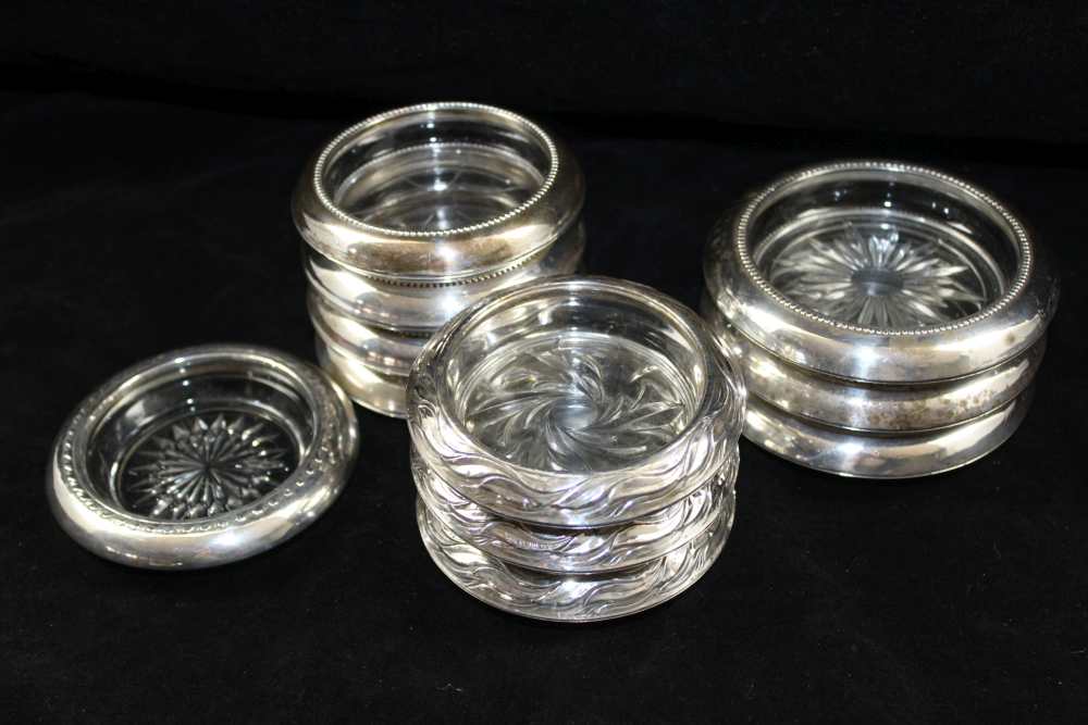 A SET OF FOUR SILVER MOUNTED MOULDED GLASS COASTERS, the four stamped 'Frank M Whiting & Co