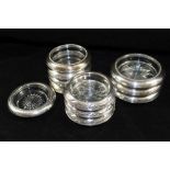 A SET OF FOUR SILVER MOUNTED MOULDED GLASS COASTERS, the four stamped 'Frank M Whiting & Co