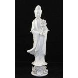 A CHINESE BLANC DE CHINE FIGURE OF GUANYIN, raised on lotus base, 37cm high
