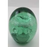 A VICTORIAN GREEN GLASS DUMP WEIGHT with floral inclusion, 13cm high