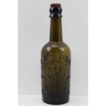 A "B.W. BROWN OF REDDITCH" MOULDED GLASS BEER BOTTLE, with Henry VIII image and the motto "A dish