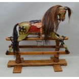 AN EARLY 20TH CENTURY ROCKING HORSE, carved wood, gesso and dapple painted with horse hair mane