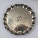 ELKINGTON & CO. A SILVER SALVER, with pie-crust rim on three feet, embossed design to centre and