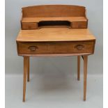 AN ERCOL LIGHT ELM WRITING TABLE, circa 1960's, having shelved superstructure, fitted two small