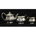 ATKIN BROTHERS A THREE-PIECE SILVER TEASET, of lobed form, comprising; teapot, milk jug and sugar
