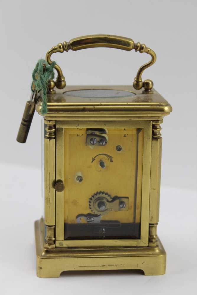 A BRASS FRAMED CARRIAGE CLOCK, with bevelled glass panels, white enamel dial with Roman numerals, - Image 2 of 3