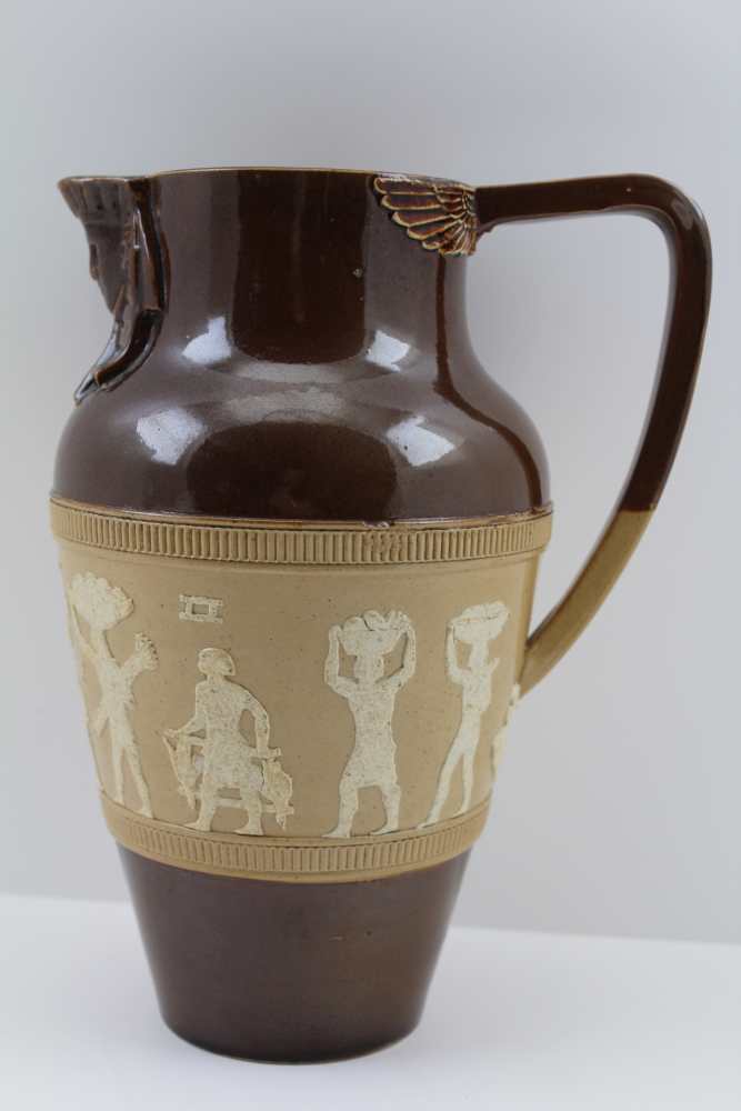 A DOULTON LAMBETH STONEWARE JUG of baluster form, part brown glazed, banded with hyraglyphs in the