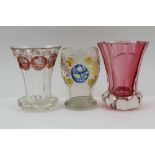 THREE 19TH CENTURY BOHEMIAN SPA GLASSES, one of cranberry trumpet form, on a clear base, one trumpet