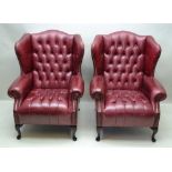 A PAIR OF LATE 20TH CENTURY DISTRESSED OX BLOOD LEATHER UPHOLSTERED WINGBACK ARMCHAIRS, having