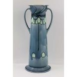 A MINTON SECESSIONIST CERAMIC VASE of tapering cylindrical form, with two handles, flared rim on