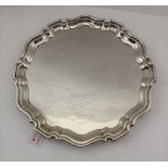 WILLIAM SUCKLING LTD A GEORGIAN DESIGN SILVER SALVER, pie-crust rim on three scroll feet (inscribed)