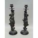 A PAIR OF PROBABLE CONTINENTAL CAST FIGURAL COLUMNED CANDLESTICKS, each depicting maiden in
