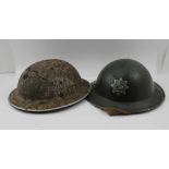 TWO SECOND WORLD WAR TIN HELMETS, one with "Bury Fire Brigade" logo, the other inscribed "129