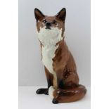A BESWICK CERAMIC SEATED FOX, impressed factory marks to base, include "Beswick" and the number "