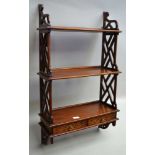 A REPRODUCTION MAHOGANY WALL UNIT, three tiers with lattice sides, the base fitted two drawers