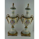 A PAIR OF LATE 20TH CENTURY CONTINENTAL POTTERY VASES, with gilt mounts, of urn form with acanthus