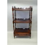A 19TH CENTURY ROSEWOOD THREE-TIER WHATNOT, wavy three-sided gallery, on turned supports, the