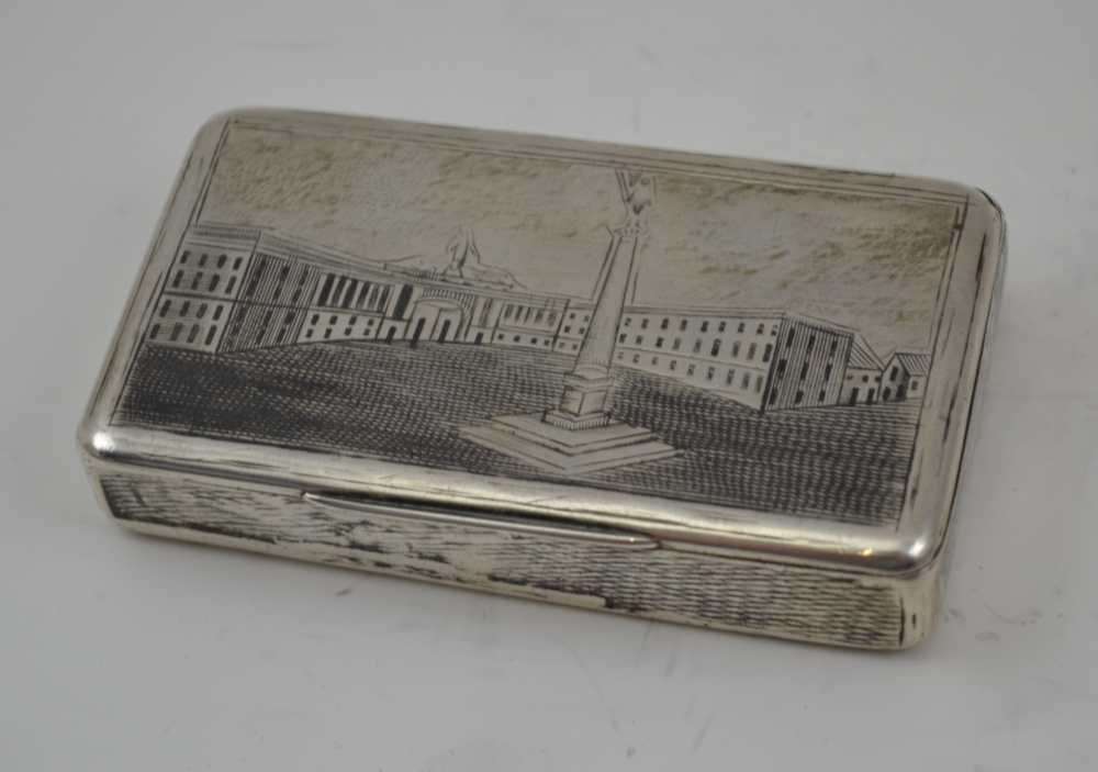 A RUSSIAN SILVER SNUFF BOX, the hinged cover and base engraved with architectural scenes, gilded