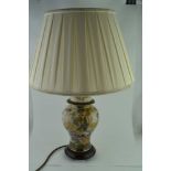 A POTTERY VASE FORM TABLE LAMP, wrythen form, moulded with two handles, floral decorated, the