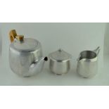 A PICQUOT WARE ALUMINIUM THREE PIECE TEA SET comprising; teapot, milk jug and a hinged cover sugar