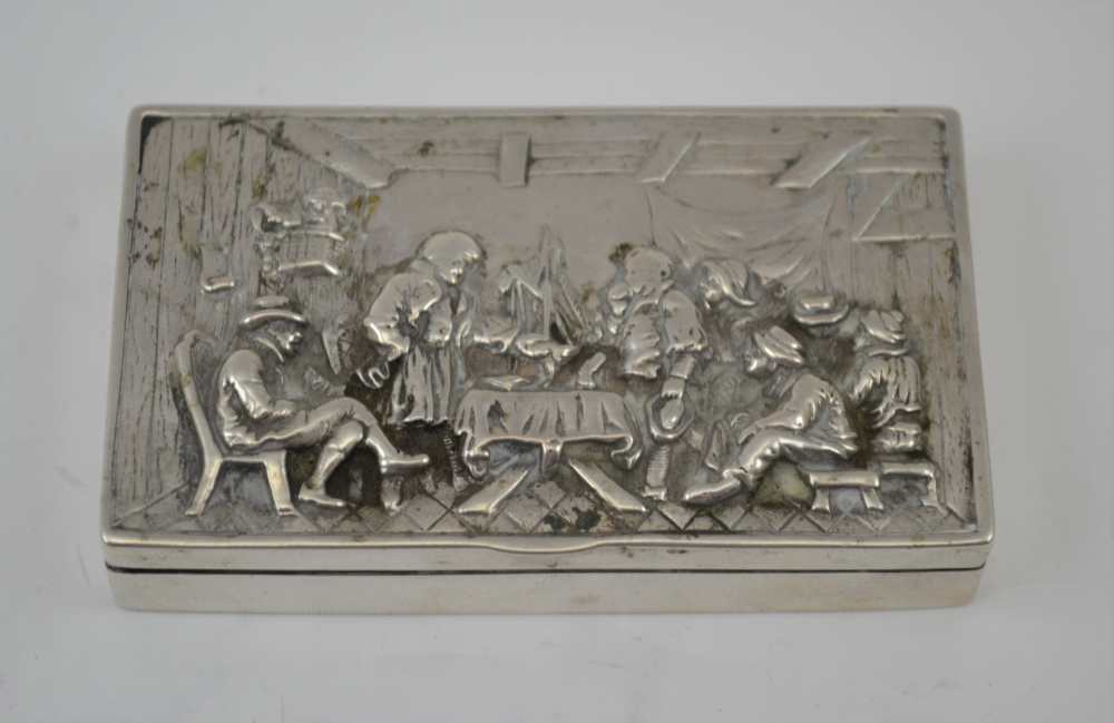 A CONTINENTAL WHITE METAL SNUFF BOX, the hinged cover embossed with a Tavern scene, 8cm x 5cm,