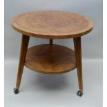 AN ART DECO DESIGN OCCASIONAL TABLE, crossbanded veneer of two tier form, 60cm diameter, with deep