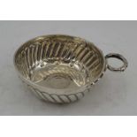 DANIEL & JOHN WELBY LTD. A SILVER "TASTEVIN" / WINE TASTING CUP, repousse fluted with entwined