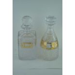 TWO LEAD CRYSTAL DECANTERS, both with gilded panel decoration, the square spirit decanter has a