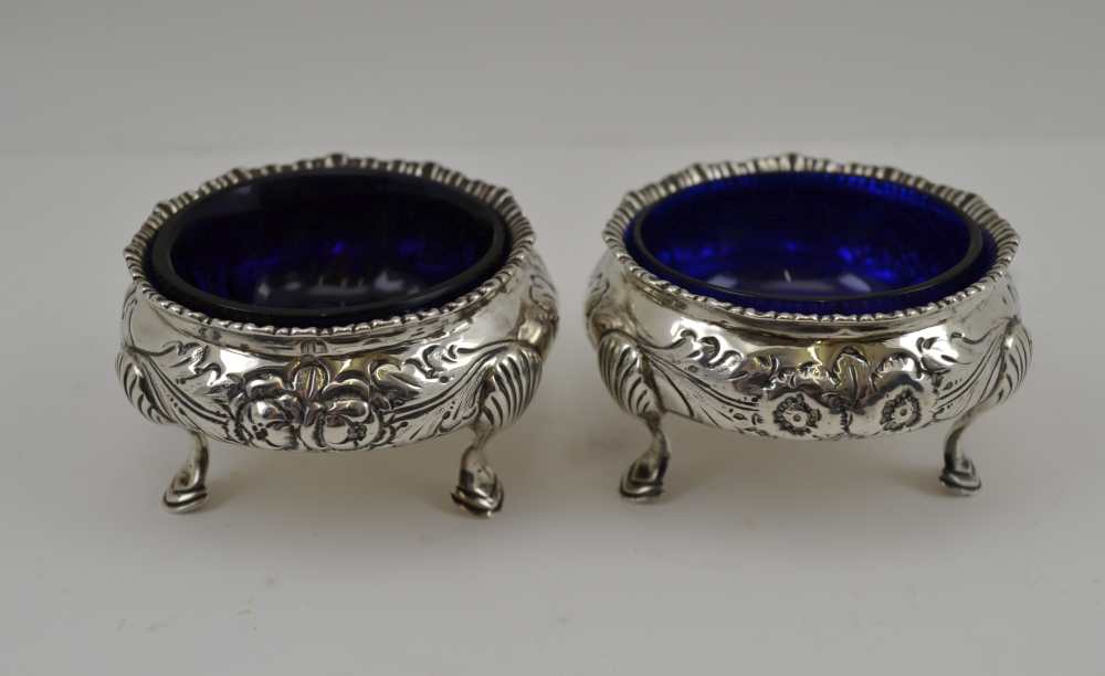 GEORGE NATHAN & RIDLEY HAYES A PAIR OF LATE VICTORIAN SILVER SALTS, Georgian design, floral repousse