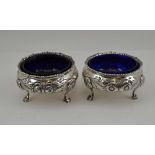 GEORGE NATHAN & RIDLEY HAYES A PAIR OF LATE VICTORIAN SILVER SALTS, Georgian design, floral repousse
