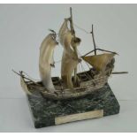 A METAL MODEL OF THE "GOLDEN HINDE" SAILING SHIP, raised upon a polished green marble base, with