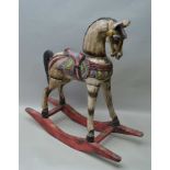 A CARVED WOOD & POLYCHROME PAINTED ROCKING HORSE, 82cm high