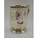 A GEORGE III SILVER TANKARD of baluster form, on circular platform base, the handle with acanthus