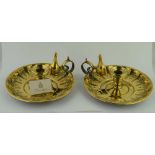 A PAIR OF ARTS & CRAFTS DESIGN BRASS CHAMBER STICKS, the lobed bases with floral decoration,