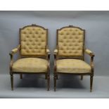 A PAIR OF FRENCH FAUTEUILS, carved gilt wood frames, floral crested backs, leaf scroll open arms, on