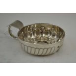 A FRENCH SILVER "TASTEVIN" / WINE TASTING CUP, raised decoration with loop handle and thumbpiece