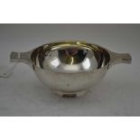 STOKES & IRELAND LTD A SILVER WHISKY QUAICH, two handled tasting bowl, of plain form, 11.3cm in